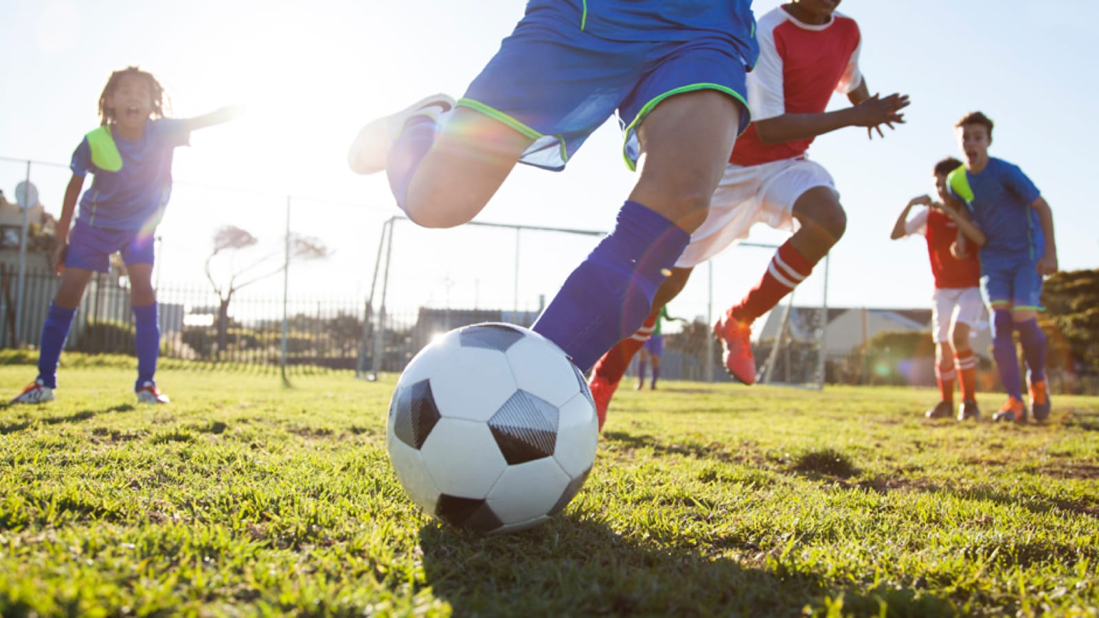 sports-gear-large Child kicking a soccer ball